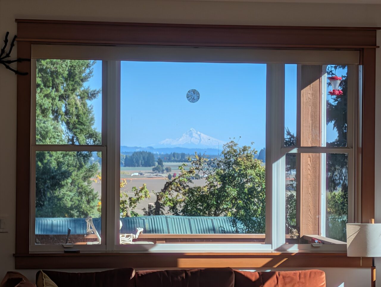 Mt. Hood, snow-covered, seen through the living room window above the valley.